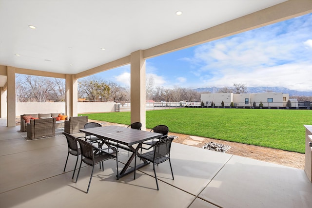 view of patio / terrace featuring an outdoor living space and a mountain view