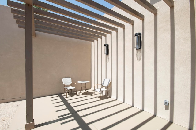 entrance to property featuring a pergola and a patio area