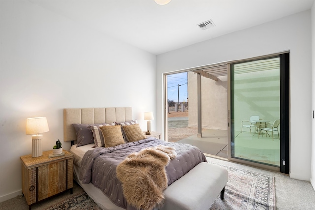 bedroom featuring light carpet and access to exterior