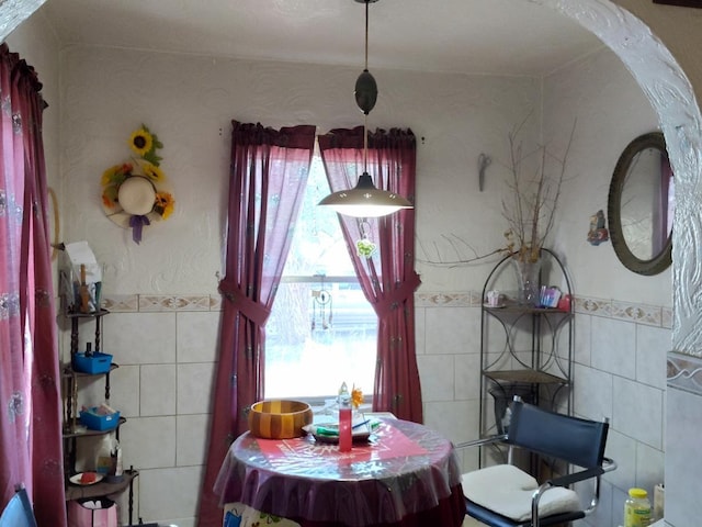 dining room with tile walls