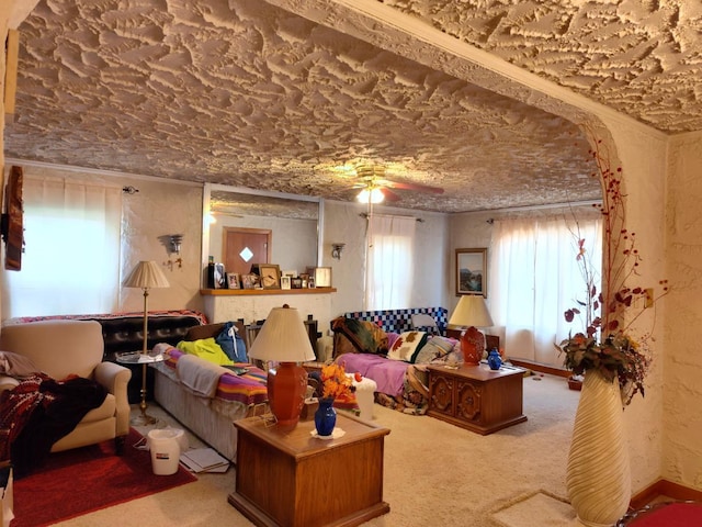 carpeted living room with ceiling fan