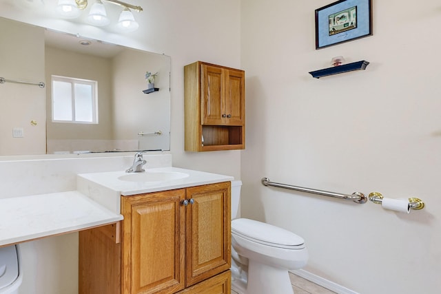 bathroom with tile patterned flooring, toilet, and vanity