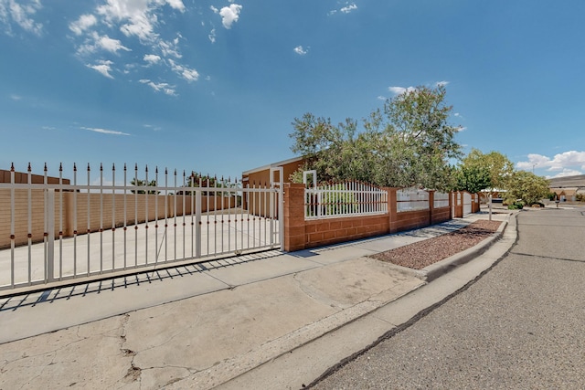 view of gate with a fenced front yard