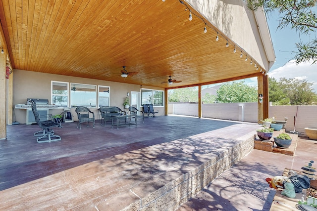 view of patio / terrace with fence and ceiling fan