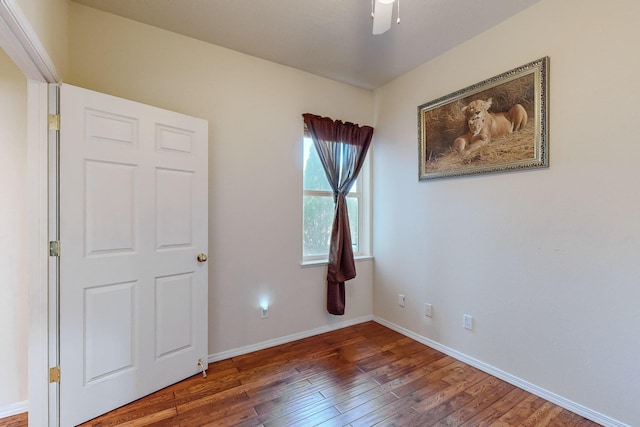 unfurnished bedroom with ceiling fan, baseboards, and wood finished floors