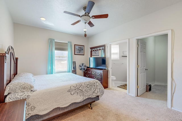 bedroom featuring connected bathroom, baseboards, carpet, ceiling fan, and a textured ceiling