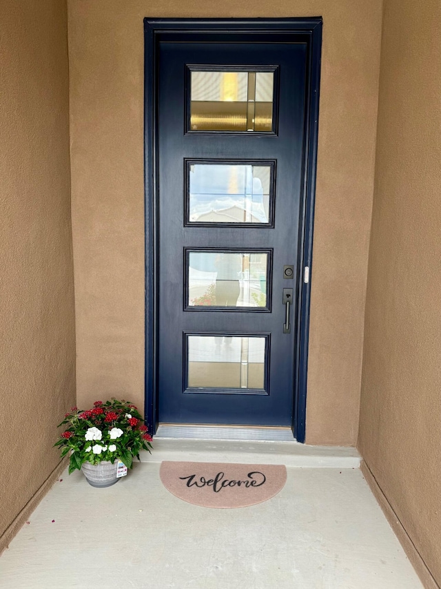 property entrance featuring stucco siding