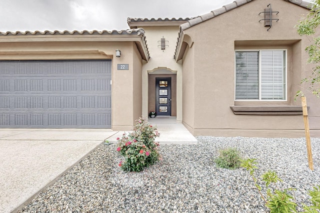 view of front of home featuring driveway, a tiled roof, and stucco siding