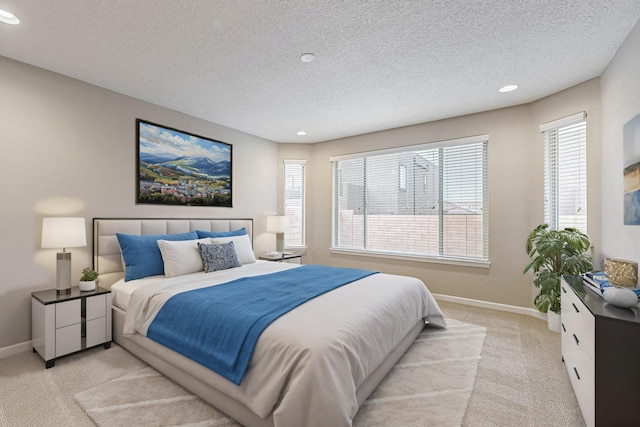 bedroom with recessed lighting, baseboards, and light colored carpet