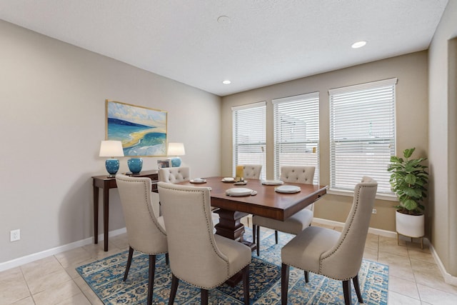 dining space with recessed lighting, a textured ceiling, baseboards, and light tile patterned floors