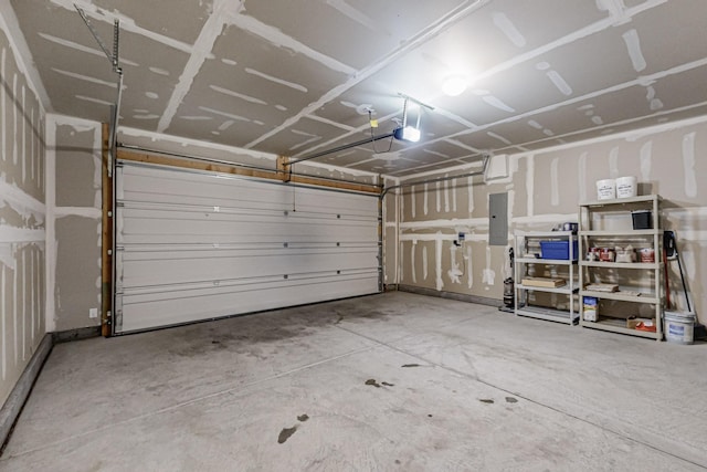 garage featuring electric panel and a garage door opener