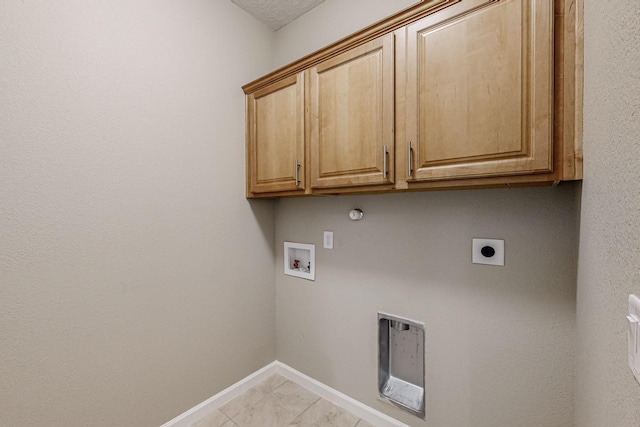 washroom featuring cabinet space, baseboards, gas dryer hookup, hookup for a washing machine, and electric dryer hookup