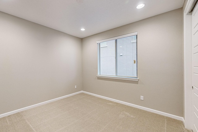 spare room featuring recessed lighting, carpet flooring, and baseboards