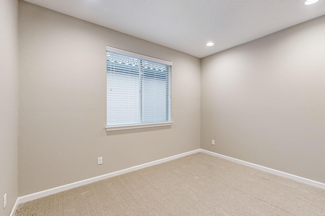 spare room featuring recessed lighting, carpet flooring, and baseboards