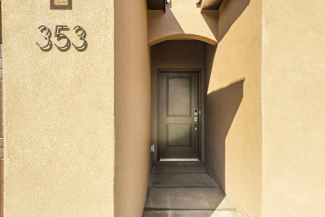 property entrance featuring stucco siding