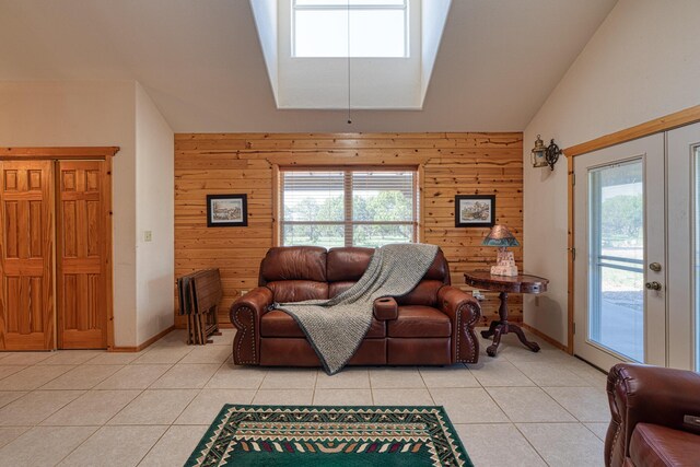 living room featuring wood walls, vaulted ceiling, and light tile patterned floors