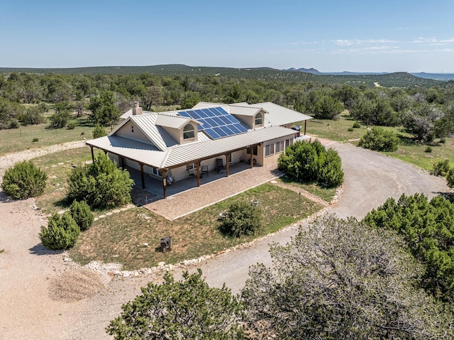 birds eye view of property featuring a forest view