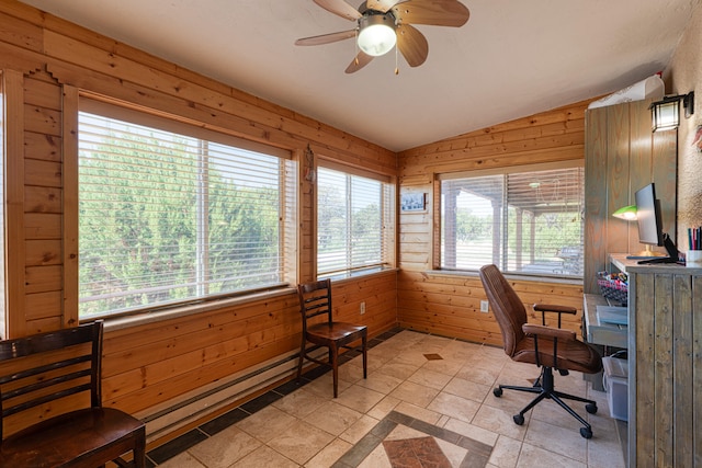 office space with ceiling fan, wooden walls, light tile patterned floors, and lofted ceiling