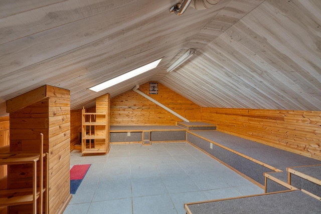 additional living space with vaulted ceiling, tile patterned flooring, wood ceiling, and wooden walls