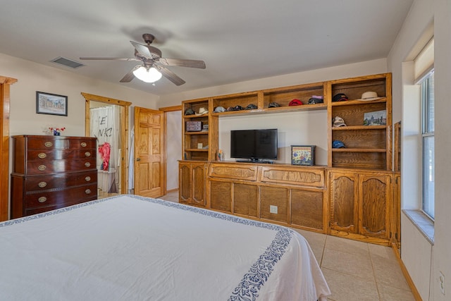 bedroom featuring ceiling fan, light tile patterned flooring, and visible vents