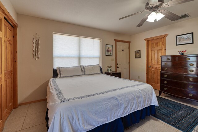 tiled bedroom featuring ceiling fan