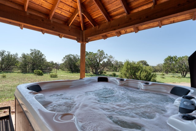 exterior space featuring a hot tub and a gazebo