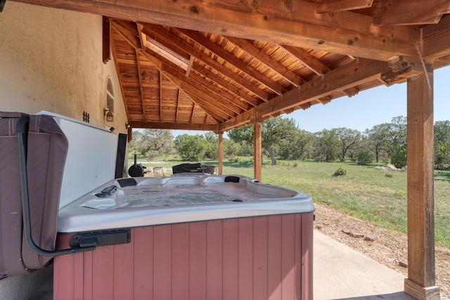 view of patio with a hot tub and a gazebo