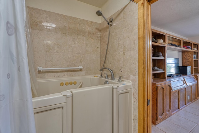 full bath featuring shower / bath combo with shower curtain, tile walls, and tile patterned floors