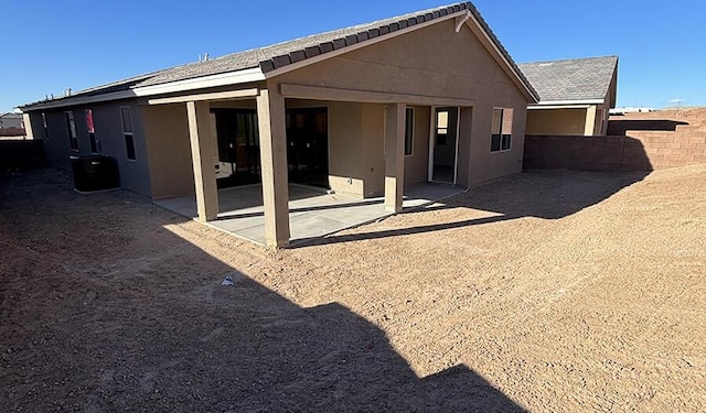 rear view of house featuring central air condition unit, a patio, and stucco siding