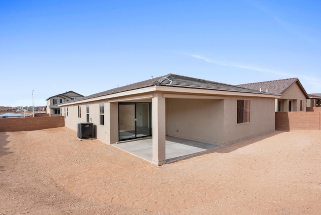 back of house featuring central air condition unit, a patio area, a fenced backyard, and stucco siding