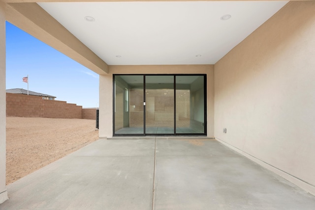 view of patio featuring fence