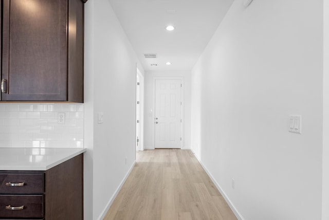 hall with baseboards, recessed lighting, visible vents, and light wood-style floors