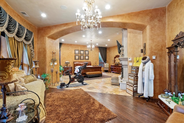 interior space with visible vents, recessed lighting, wood finished floors, arched walkways, and a notable chandelier