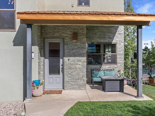 doorway to property featuring a patio area and an outdoor hangout area