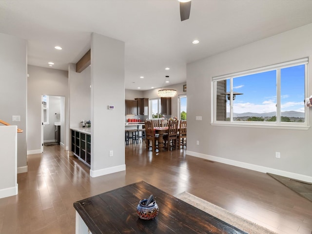 living room with ceiling fan and dark hardwood / wood-style floors