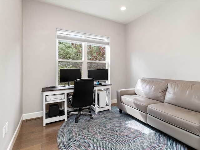 home office with dark wood-type flooring