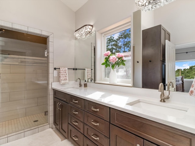 bathroom featuring walk in shower, plenty of natural light, vanity, and an inviting chandelier