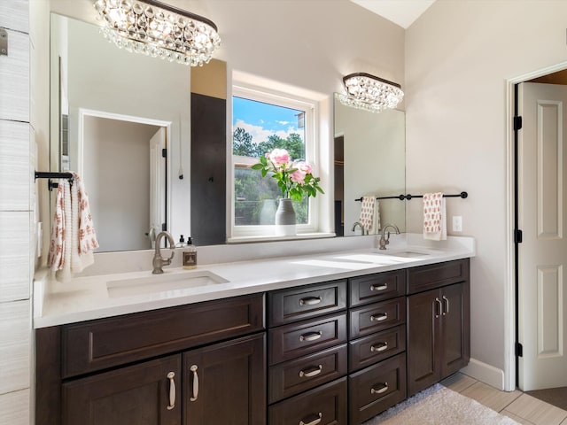 bathroom featuring a notable chandelier and vanity