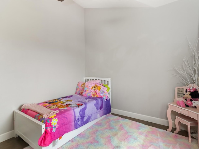 bedroom with dark hardwood / wood-style floors