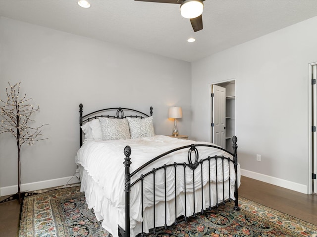 bedroom with ceiling fan and dark hardwood / wood-style flooring