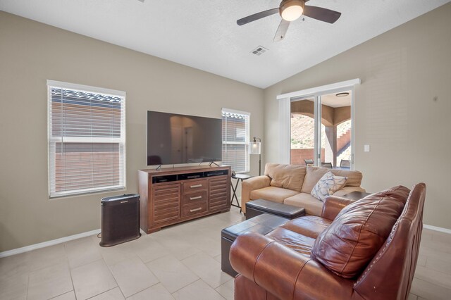 living room featuring ceiling fan, vaulted ceiling, and light tile patterned flooring