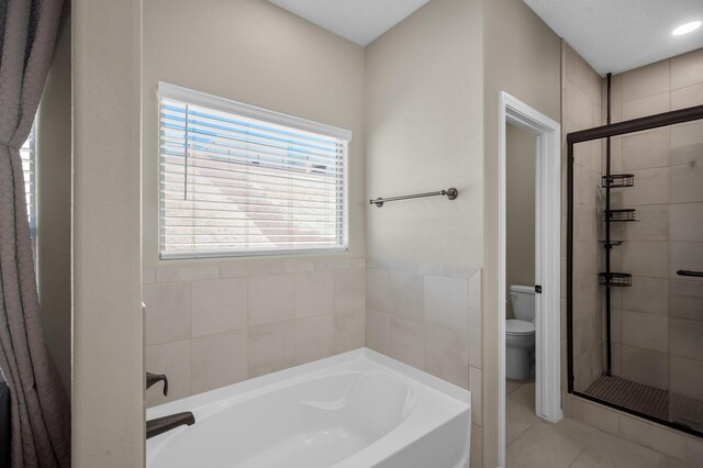 bathroom with toilet, independent shower and bath, and tile patterned flooring