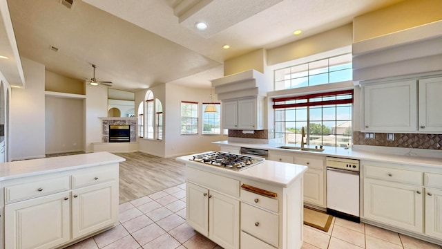 kitchen featuring ceiling fan, stainless steel appliances, light tile patterned floors, tasteful backsplash, and sink