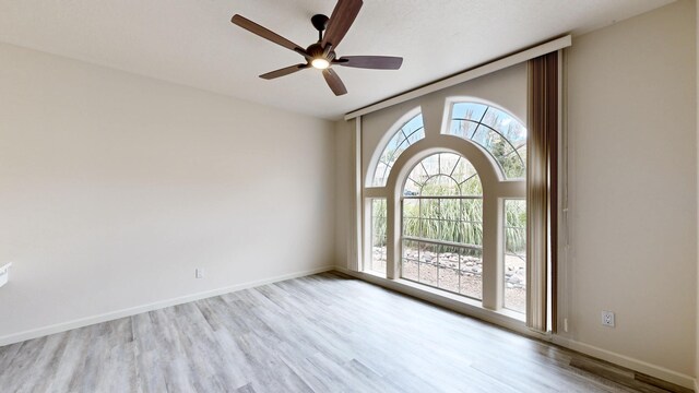 spare room with light hardwood / wood-style flooring and ceiling fan