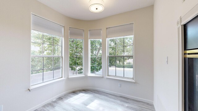 spare room with hardwood / wood-style flooring