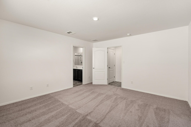 961 Berman St SW, Albuquerque, NM 87121 - unfurnished bedroom with light colored carpet, visible vents, baseboards, and ensuite bathroom