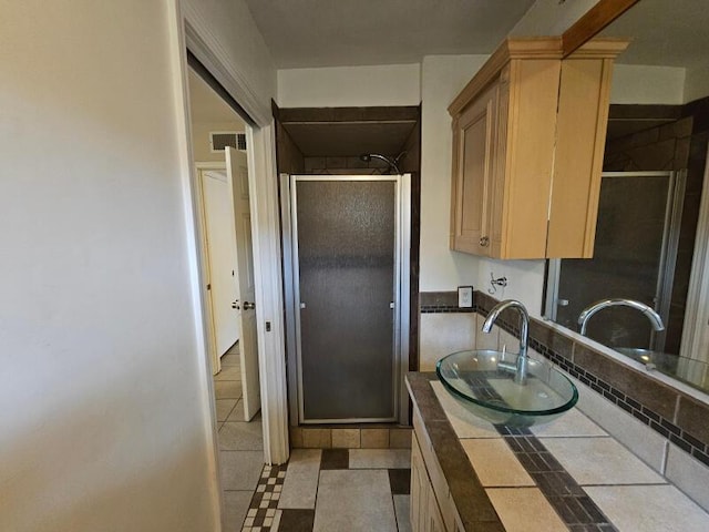 full bathroom with visible vents, a stall shower, and vanity