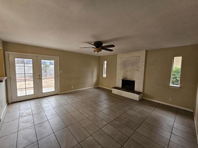 unfurnished living room with a wealth of natural light, tile patterned flooring, and a fireplace