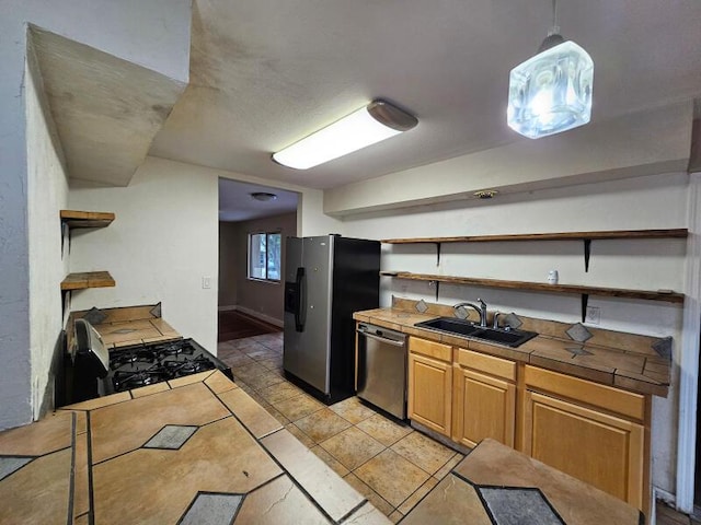 kitchen featuring light tile patterned floors, open shelves, a sink, stainless steel appliances, and tile counters