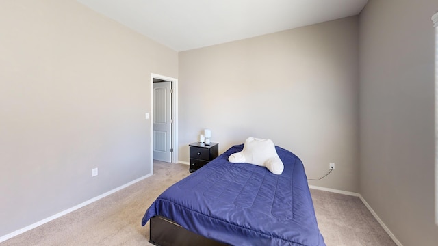 bedroom featuring light carpet